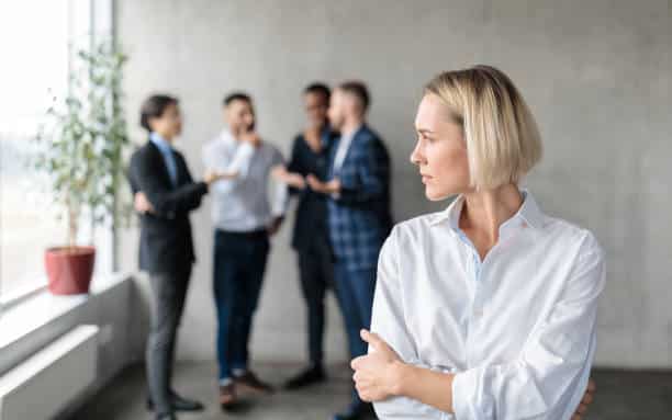 Pensive female executive in a modern office setting, representing the corporate glass ceiling and the challenges of high-level leadership communication.